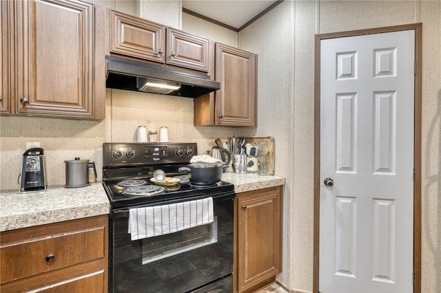2095 Fm 1452 W, Madisonville, TX 77864 - kitchen featuring black electric range oven, light countertops, backsplash, under cabinet range hood, and ornamental molding