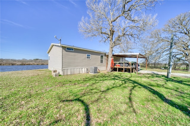 2095 Fm 1452 W, Madisonville, TX 77864 - back of property featuring a deck with water view, a lawn, and cooling unit