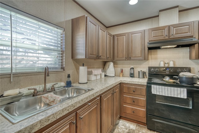 2095 Fm 1452 W, Madisonville, TX 77864 - kitchen featuring black electric range, a sink, under cabinet range hood, light countertops, and brown cabinetry