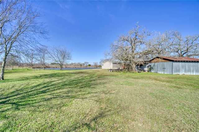 2095 Fm 1452 W, Madisonville, TX 77864 - view of green lawn with a water view, an outdoor structure, and an outbuilding