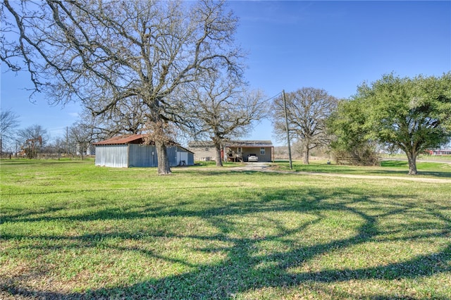 2095 Fm 1452 W, Madisonville, TX 77864 - view of grassy yard with an outbuilding