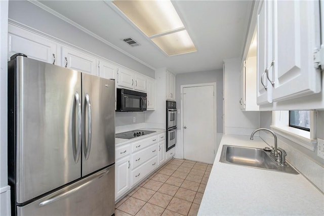 1011 Val Verde Dr, College Station, TX 77845 - kitchen featuring black appliances, white cabinets, light countertops, light tile patterned floors, and crown molding