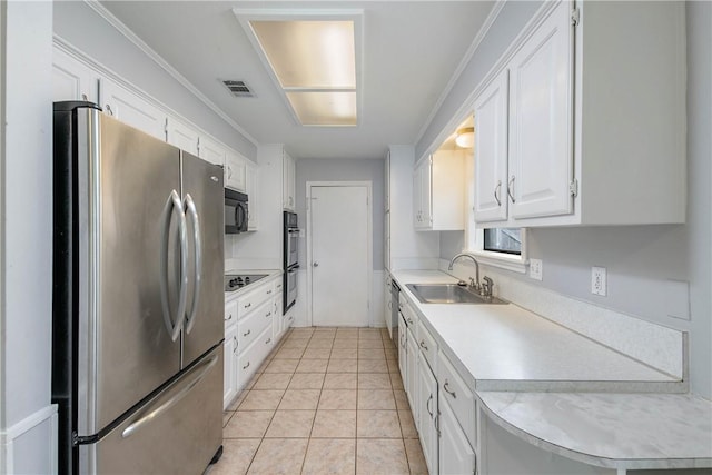 1011 Val Verde Dr, College Station, TX 77845 - kitchen featuring black appliances, light countertops, white cabinetry, light tile patterned flooring, and crown molding