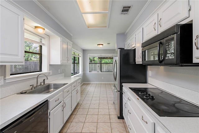 1011 Val Verde Dr, College Station, TX 77845 - kitchen featuring black appliances, white cabinetry, light countertops, and light tile patterned floors