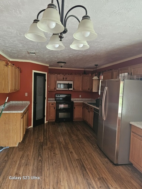 kitchen featuring dark hardwood / wood-style flooring, black appliances, and a textured ceiling