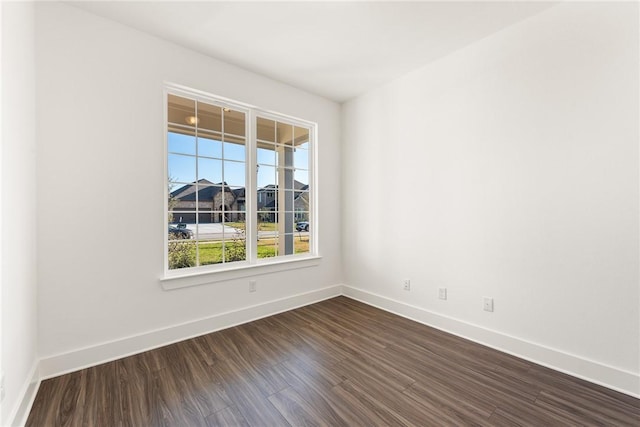 unfurnished room with dark hardwood / wood-style floors