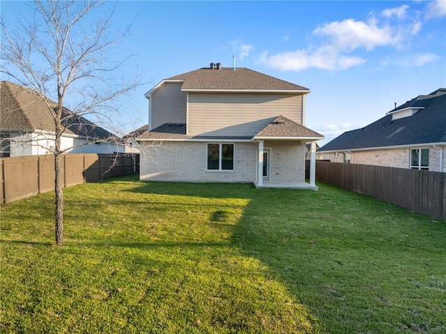 rear view of house featuring a lawn