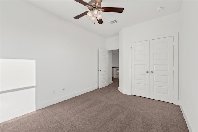 unfurnished bedroom with carpet flooring, ceiling fan, and a closet