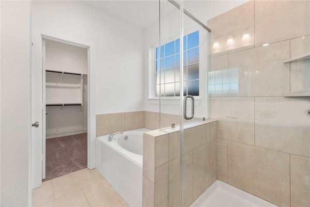 bathroom featuring tile patterned floors and shower with separate bathtub