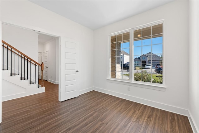 unfurnished room featuring dark wood-type flooring