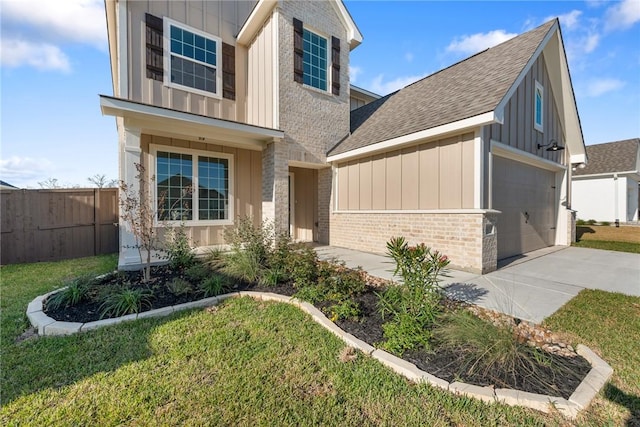 view of front of home featuring a garage and a front yard