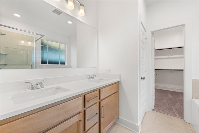 bathroom with tile patterned flooring, vanity, and an enclosed shower