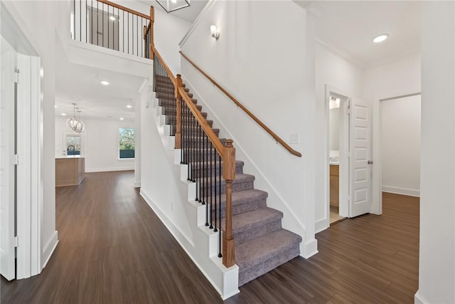 stairs with a chandelier and wood-type flooring