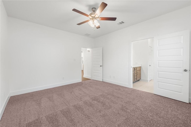 unfurnished bedroom featuring ensuite bathroom, ceiling fan, and light colored carpet