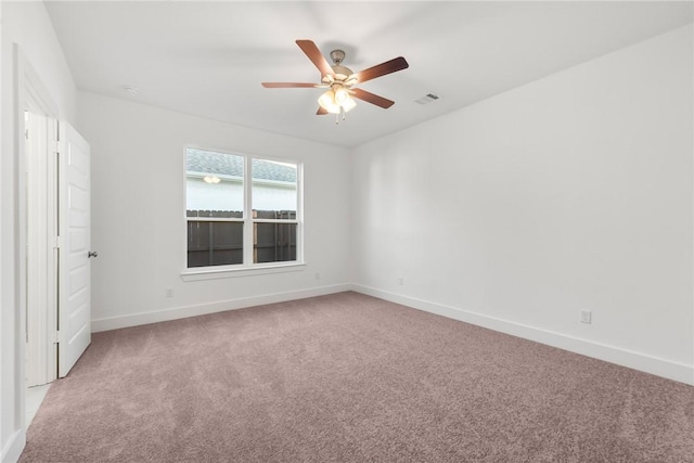 unfurnished room with carpet and ceiling fan