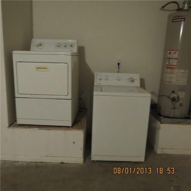laundry area with water heater and washer and clothes dryer