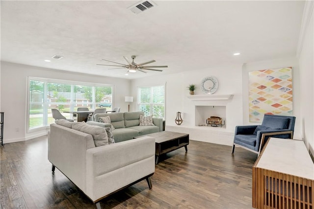 living room featuring dark hardwood / wood-style floors and ceiling fan