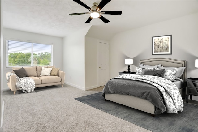 carpeted bedroom with ceiling fan and a closet