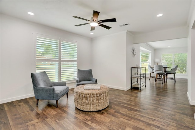 living area with dark hardwood / wood-style floors and ceiling fan