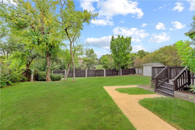 view of yard with a deck and a storage shed