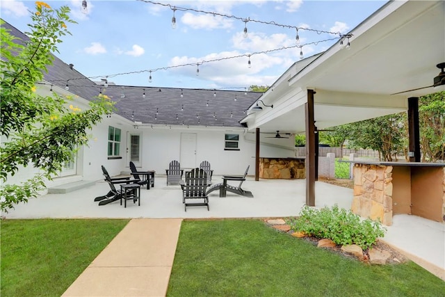 exterior space featuring ceiling fan and a bar