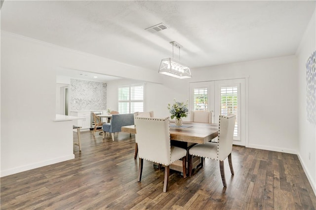 dining room featuring dark hardwood / wood-style floors and ornamental molding