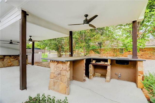 view of patio featuring exterior bar and ceiling fan