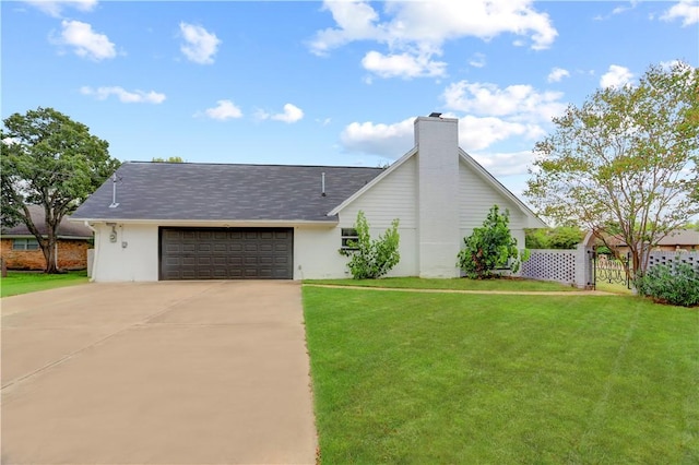 view of front of home featuring a garage and a front yard