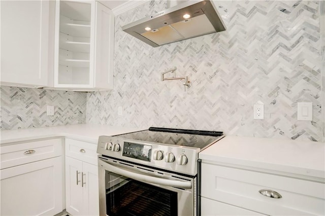 kitchen with white cabinetry, stainless steel electric range oven, and wall chimney exhaust hood