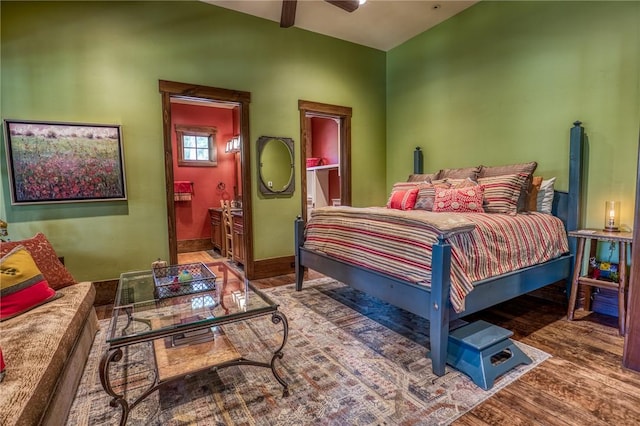 bedroom with ensuite bath, ceiling fan, and hardwood / wood-style flooring