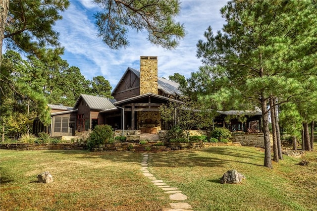 rear view of house featuring a lawn