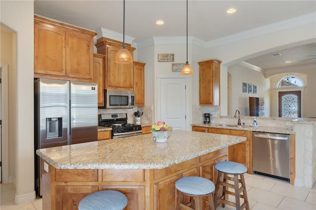 kitchen featuring ornamental molding, a sink, a center island, stainless steel appliances, and light tile patterned floors