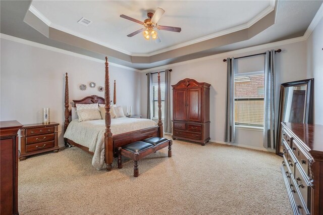 bedroom with a raised ceiling and multiple windows