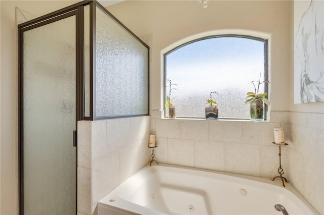 full bathroom featuring a stall shower and a whirlpool tub