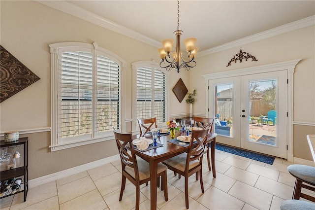 dining area featuring a notable chandelier, plenty of natural light, french doors, and ornamental molding