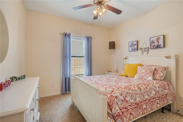 bedroom with light colored carpet, baseboards, and ceiling fan