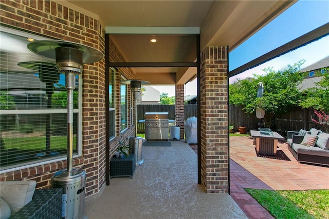view of patio / terrace with grilling area, a fenced backyard, and an outdoor hangout area