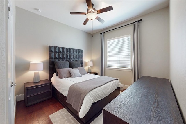 bedroom with wood finished floors, ceiling fan, and baseboards
