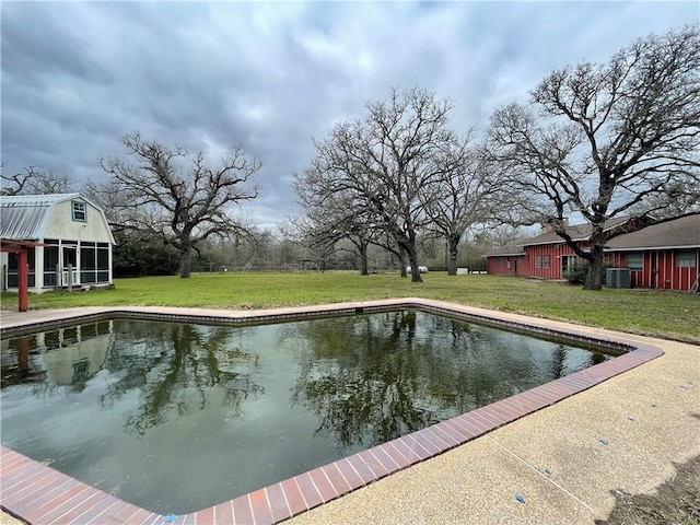 outdoor pool with a lawn, an outdoor structure, and cooling unit