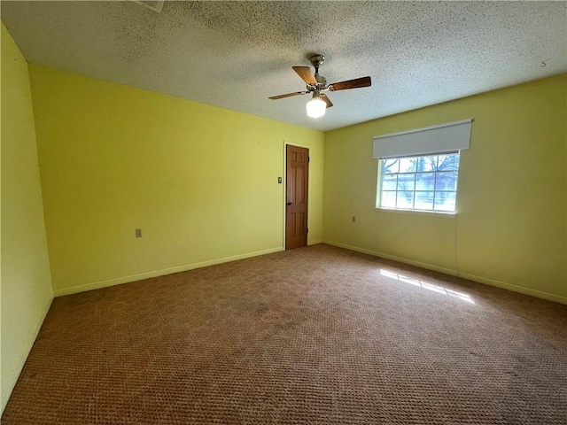 spare room featuring a ceiling fan, carpet flooring, a textured ceiling, and baseboards