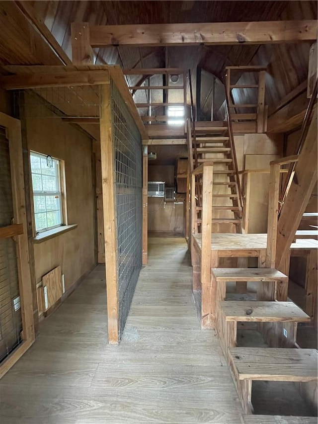 interior space featuring vaulted ceiling, radiator heating unit, and wood finished floors