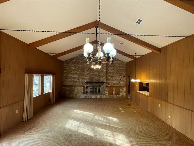 unfurnished living room with light carpet, lofted ceiling with beams, a brick fireplace, and wooden walls