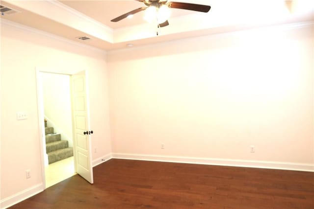 2123 Chestnut Oak Cir, College Station, TX 77845 - unfurnished room with dark wood-type flooring, ornamental molding, a raised ceiling, ceiling fan, and stairs