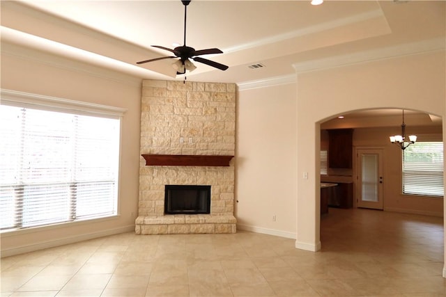 2123 Chestnut Oak Cir, College Station, TX 77845 - unfurnished living room with a tray ceiling, ceiling fan, a chandelier, ornamental molding, and a stone fireplace