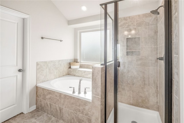 full bathroom featuring tile patterned floors, a shower stall, and a bath