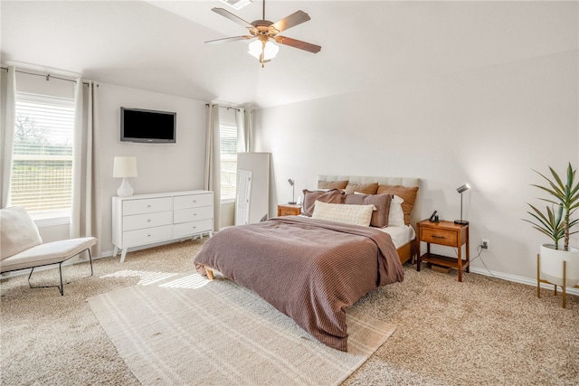 bedroom featuring light carpet, vaulted ceiling, a ceiling fan, and baseboards