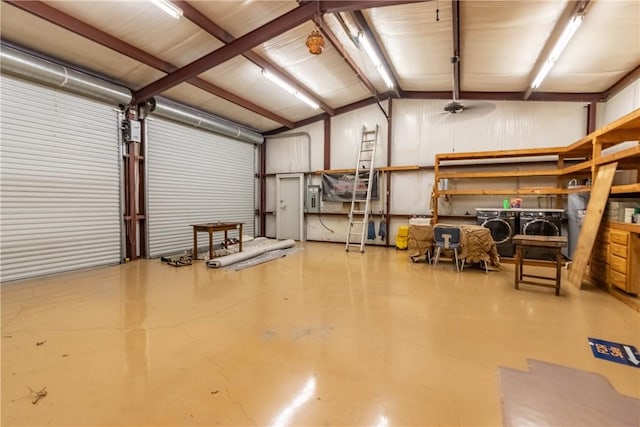 garage featuring independent washer and dryer and ceiling fan