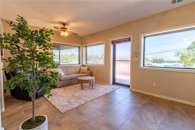 living room with ceiling fan and light tile patterned floors