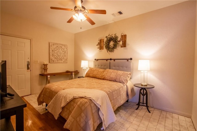 bedroom with ceiling fan and light hardwood / wood-style flooring