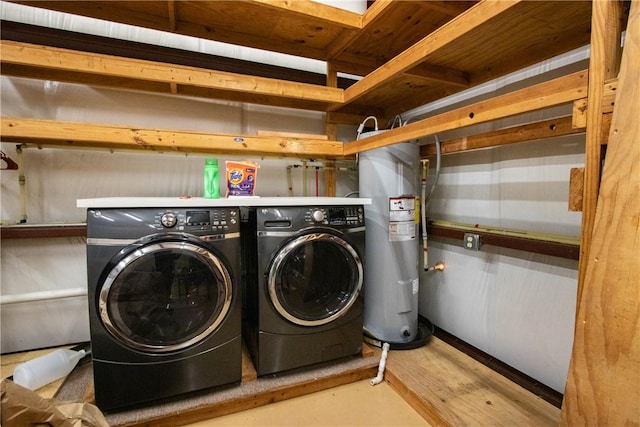 washroom with electric water heater and separate washer and dryer